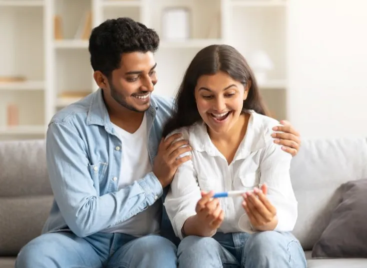 Couple feeling happy after a positive pregnancy test
